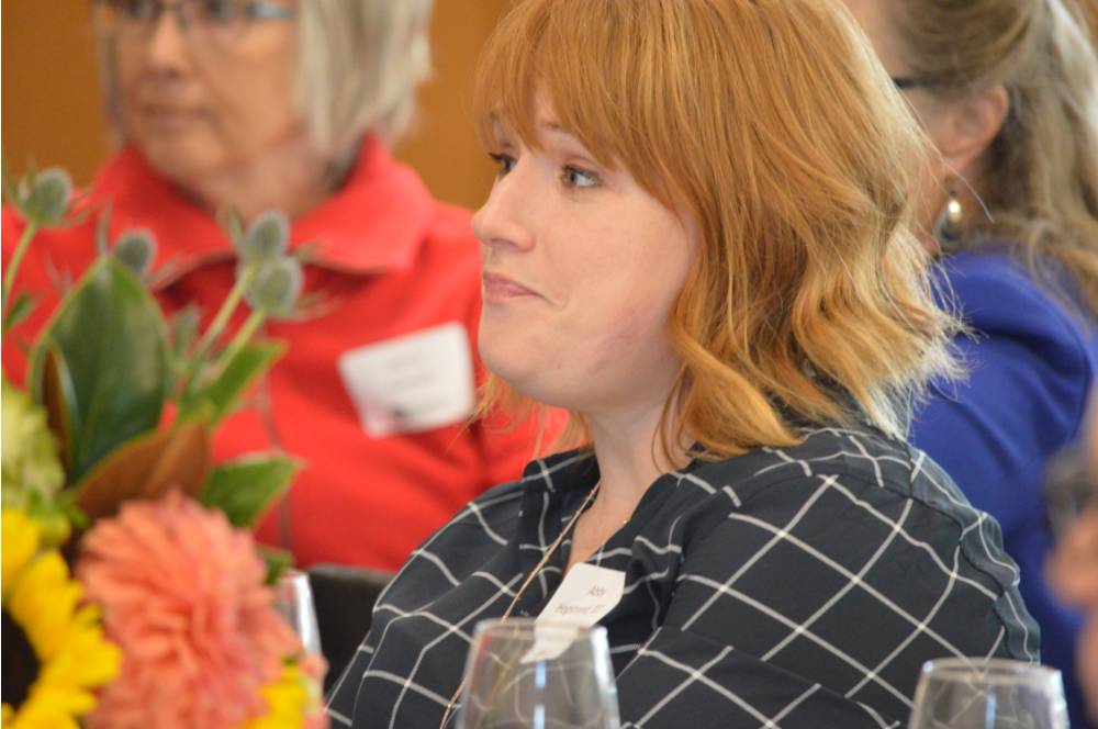 An alumna engaged in listening to a speaker